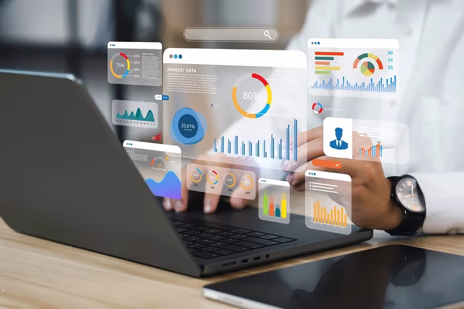 Person at a laptop with floating business analytics dashboards