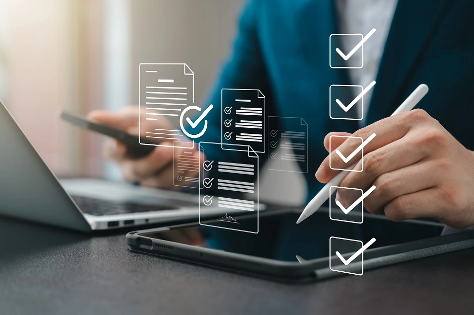 Businessman checking off digital document checklist icons on a tablet