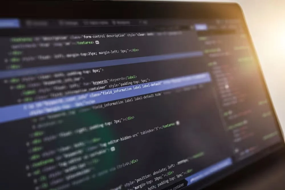 Laptop screen showing lines of web page code