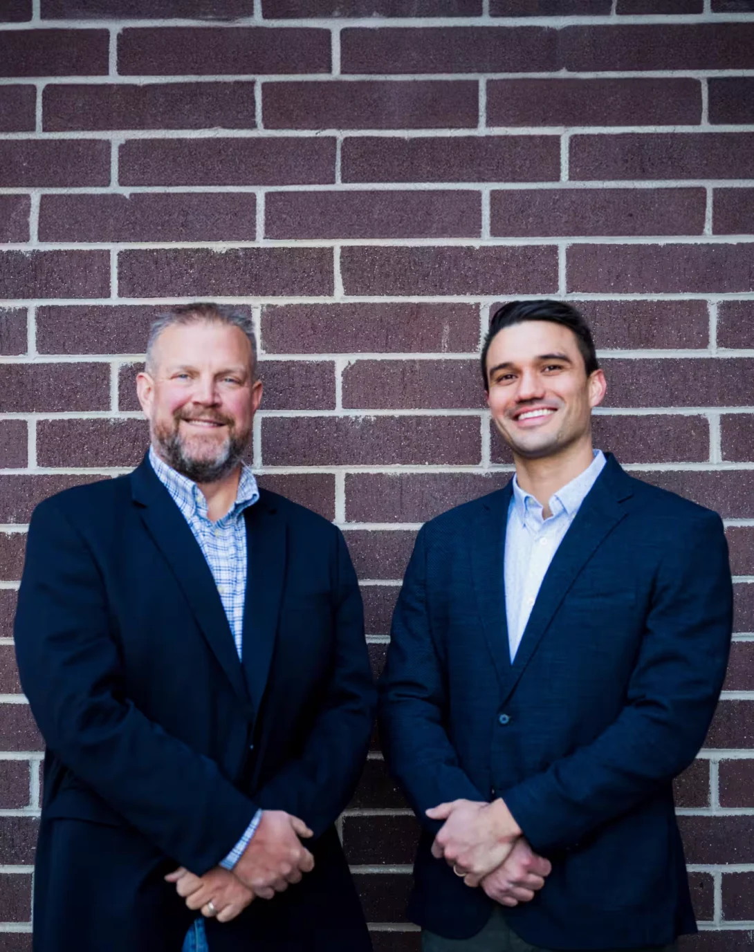 Andrew Lopez and Hunter Boone in front of a brick wall